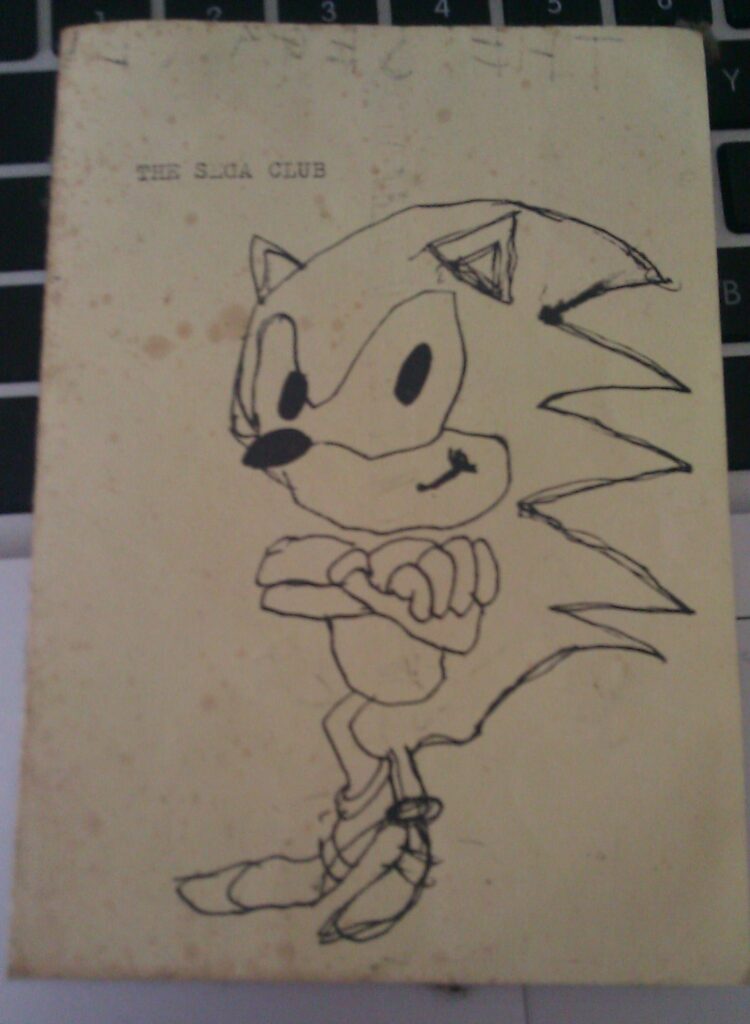 Zine cover of a hand-drawn sketch of Sonic the Hedgehog labelled The Sega Club on cream paper with ink. 1990s era fan art.