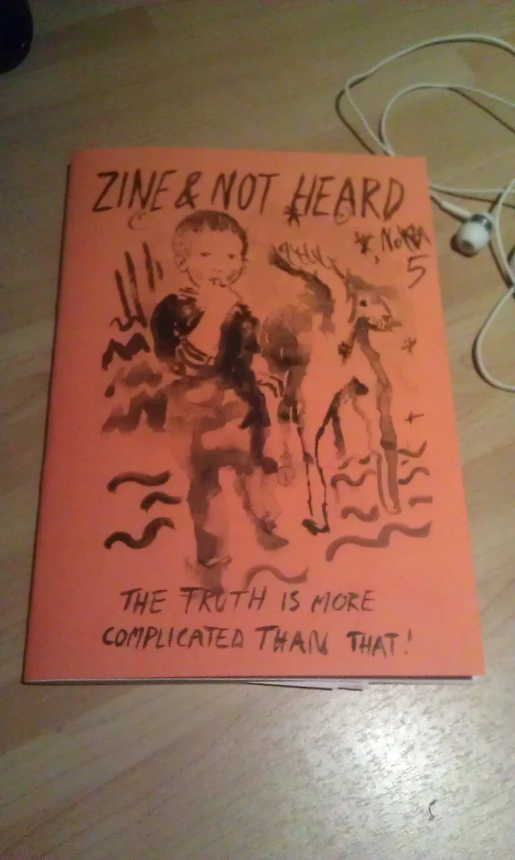 Orange zine cover titled ZINE & NOT HEARD NO. 5 with a sketch of a child and dog, and text reading THE TRUTH IS MORE COMPLICATED THAN THAT!